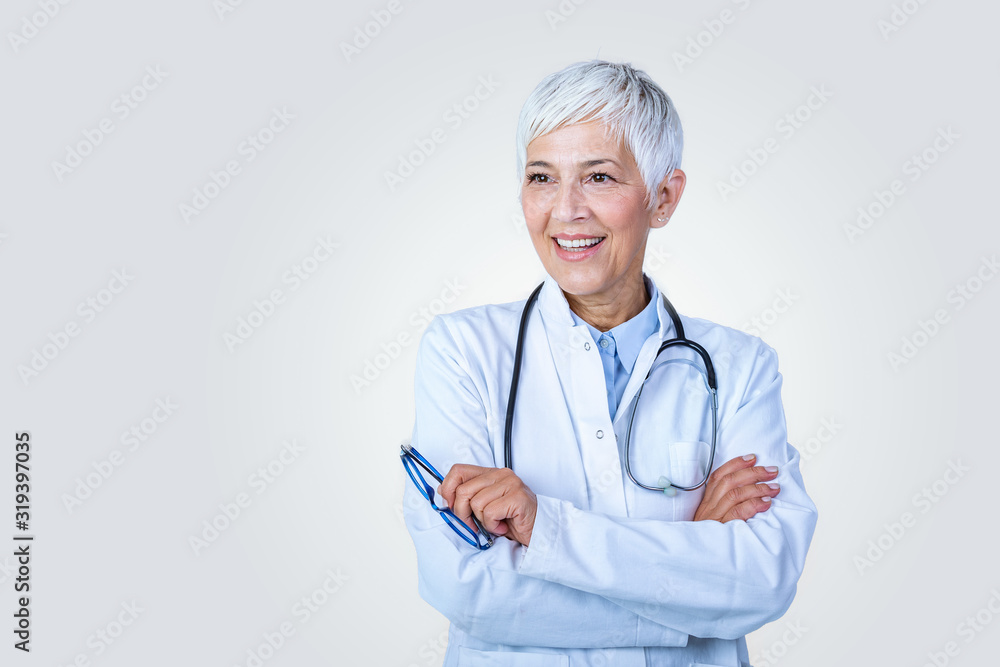 Portrait of senior female doctor with stethoscope & arm cross isolated on background. The physician standing with cheerful gesturing. She wearing doctor uniform in hospital. Health insurance concept.