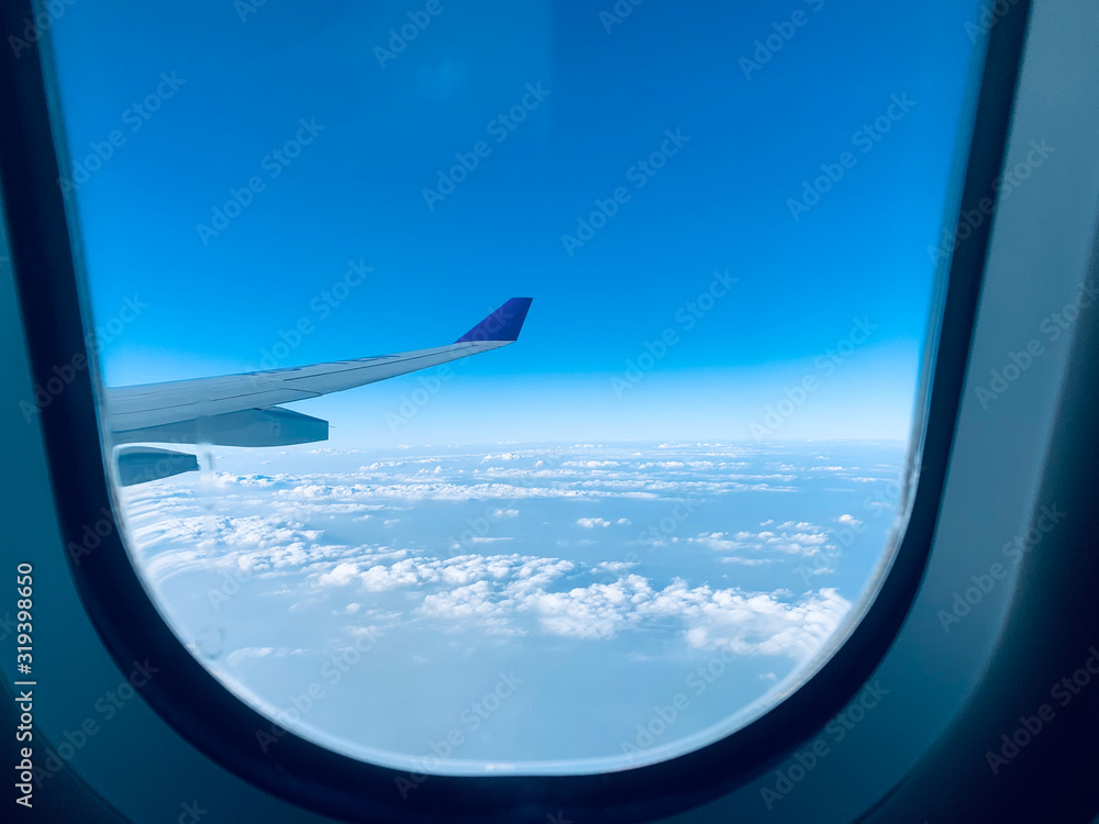 The windows and wings of the plane saw the clouds. The windows and wings of the plane saw the clouds.