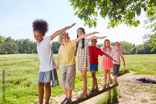 Children balancing on a beam photo