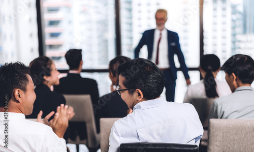 Businessman standing in front of group of people in consulting meeting conference seminar at hall or seminar room.presentation and coaching concept