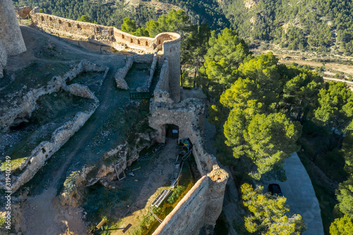 Aerial view of the ruined inner castle structure of medieval Gothic Jalance castle with castle gate near Cofrentes Spain photo
