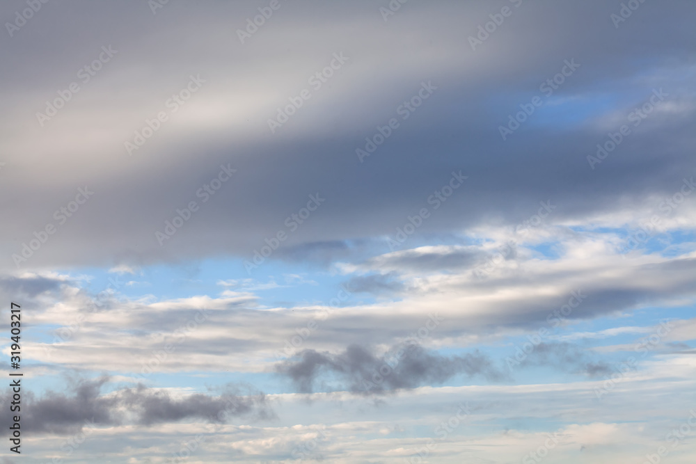Gray and white clouds on a background of blue sky. heavenly landscape before changing weather