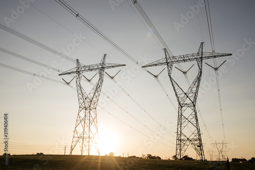 landscape of powerlines with sunset in background. photo