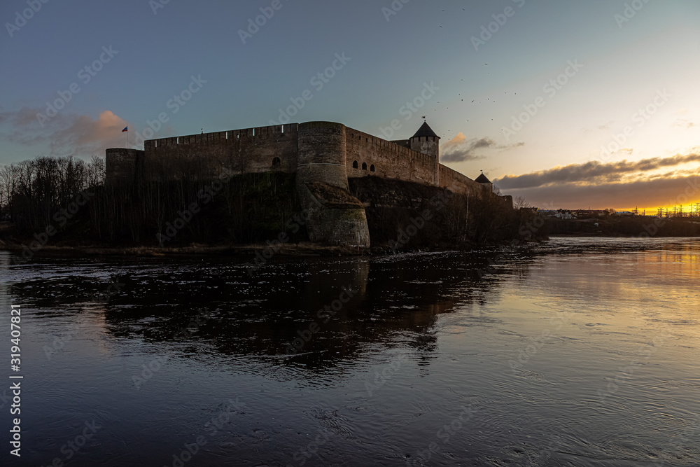 Beautiful winter dawn over the river and the fortress. Noise effect applied