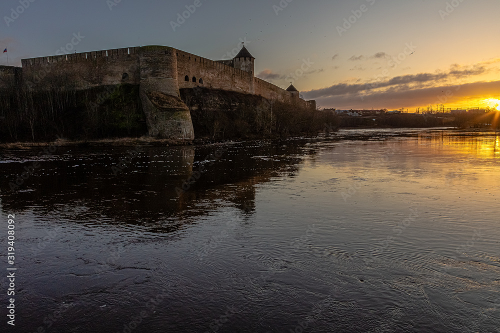 Beautiful winter dawn over the river and the fortress. Noise effect applied