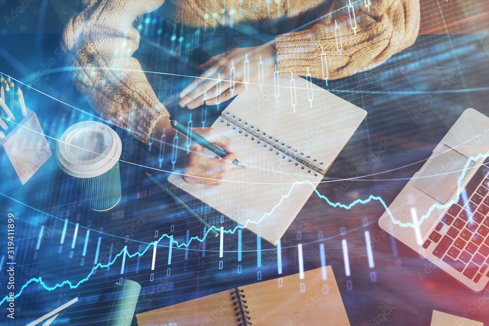 Forex graph on hand taking notes background. Concept of research. Double exposure Forex graph on hand taking notes background. Concept of research. Double exposure