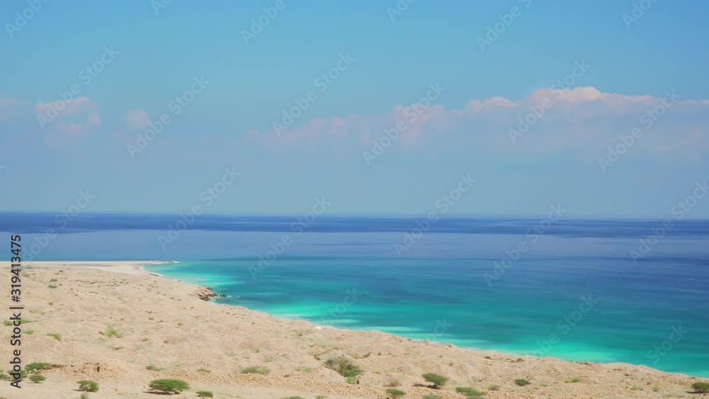 Oman Coast Landscape with White Sandy Beach and Turquoise Sea Water Oman Coast Landscape with White Sandy Beach and Turquoise Sea Water