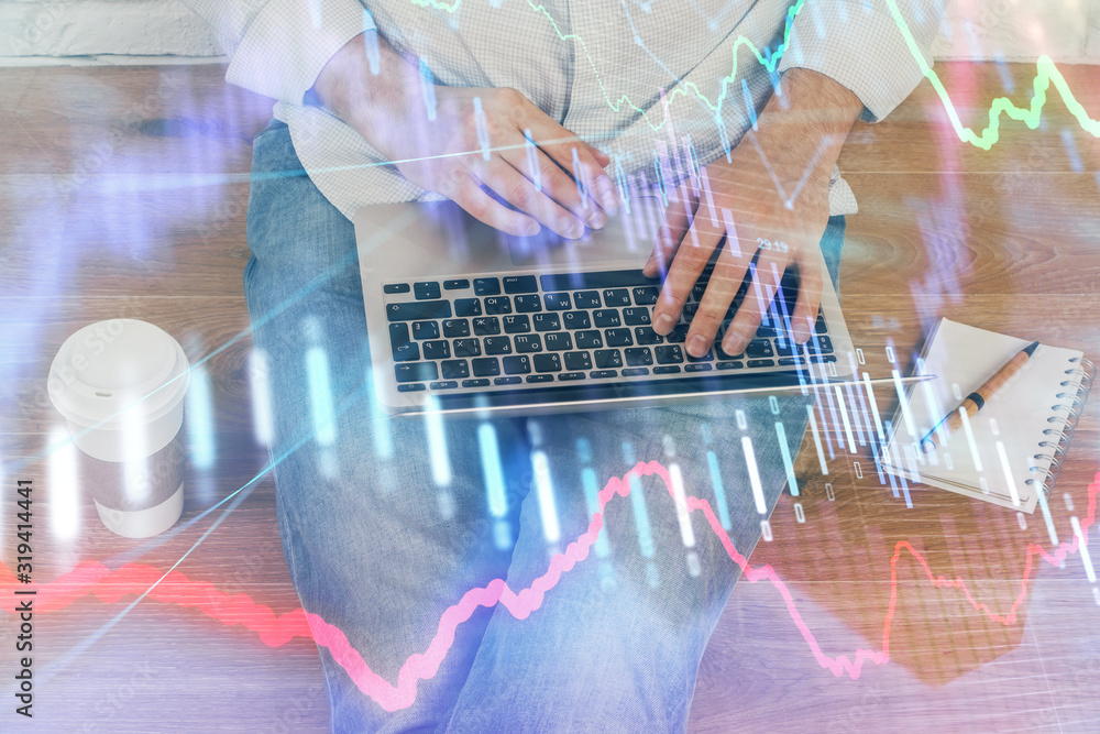 Forex graph with businessman working on computer in office on background. Concept of analysis. Double exposure. Forex graph with businessman working on computer in office on background. Concept of analysis. Double exposure.