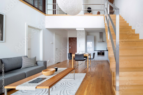 Two-floor open space apartment with wooden stairs and hardwood floor