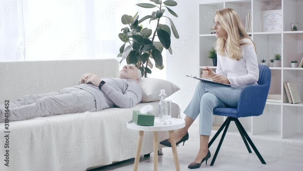 mature sportsman lying on couch and talking to psychologist mature sportsman lying on couch and talking to psychologist