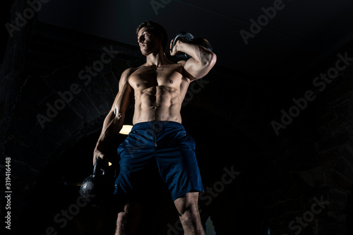 Wallpaper Mural Fit muscular bodybuilder man posing on dark background Torontodigital.ca