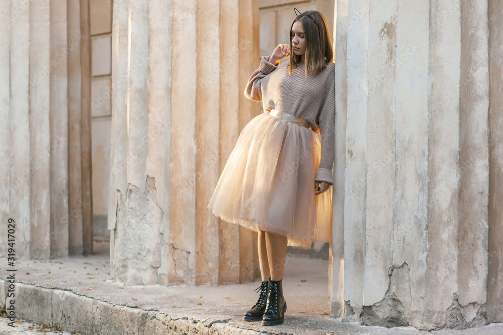 Teen girl in brown tulle skirt and autumn sweater