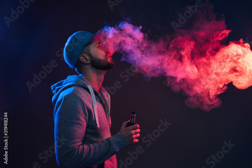 Vaping e-liquid from an electronic cigarette photo
