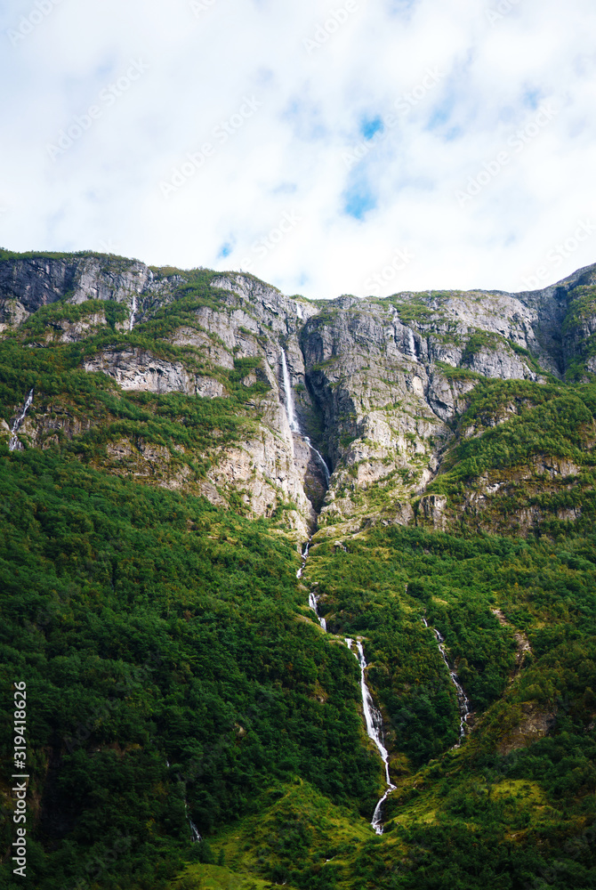 Norway landscape with big waterfall. Picturesque landscape mountains of Norway. Travelling, lifestyle, wild nature concept.