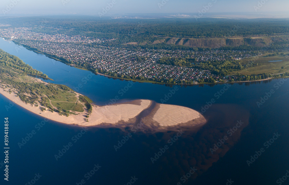 Aerial view of the river of Volga near the city of Tolyatti with sandy coast during a calm sunrise, Russia Aerial view of the river of Volga near the city of Tolyatti with sandy coast during a calm sunrise, Russia