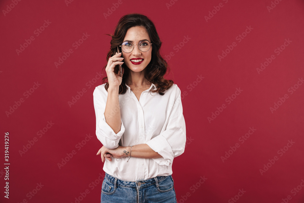 Woman in glasses talking by mobile phone. Woman in glasses talking by mobile phone.