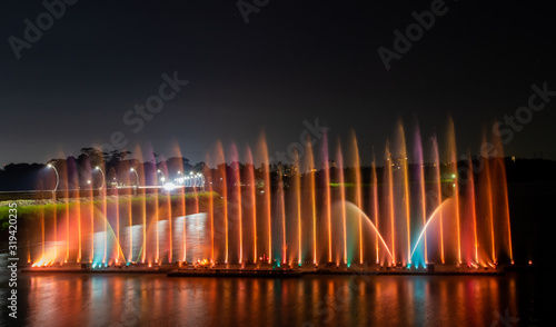 Night show of color fountains. Beautiful fountain show. Dancing fountain at Lantan Scenic Area in Taiwan