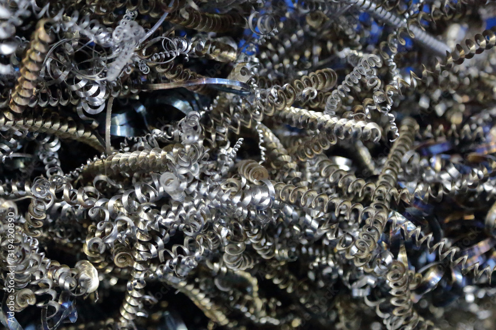 Textured surface of spiral-shaped iron chips after turning a blank on a lathe Textured surface of spiral-shaped iron chips after turning a blank on a lathe