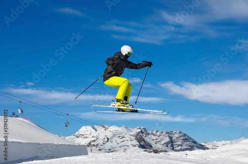 Skier jumps in snow park