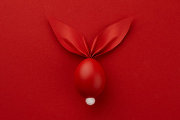 Red Easter egg with paper bunny ears