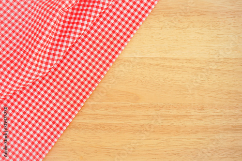 red tablecloth on wooden background