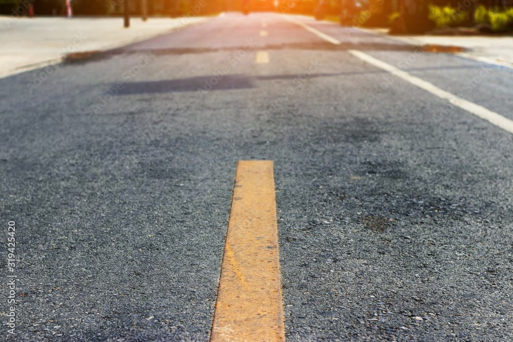 Obraz premium The asphalt road has yellow dividing line.