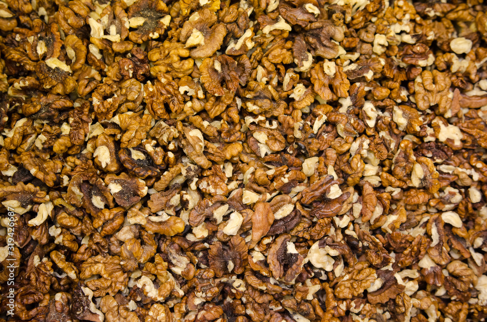 Walnuts with and without shells (filling the picture). Background of fresh walnuts. Walnuts with and without shells (filling the picture). Background of fresh walnuts.