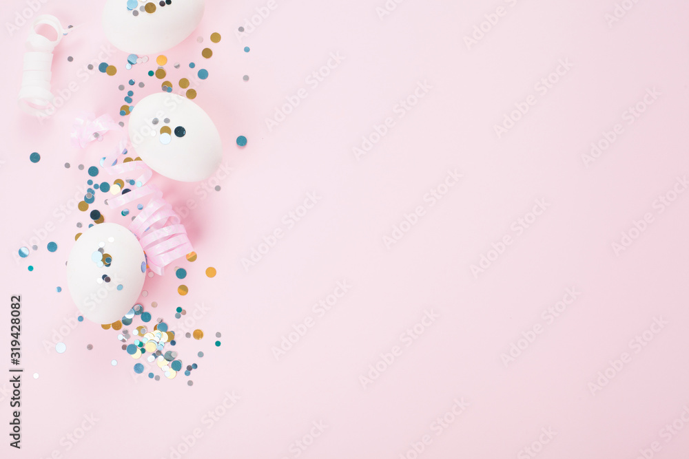 White eggs on a pink background, decorated with a gold bow, festive sparkles, with copy space. Easter concept.