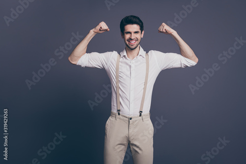 Don't forget about gym training. Photo of macho business man raise two big biceps dressed formalwear white shirt beige suspenders trousers isolated grey color background