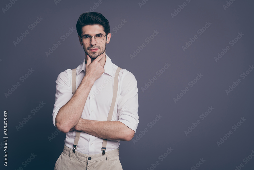 Photo of attractive business man charming appearance holding arm on chin deep minded dressed formalwear white shirt beige suspenders specs isolated grey color background Photo of attractive business man charming appearance holding arm on chin deep minded dressed formalwear white shirt beige suspenders specs isolated grey color background