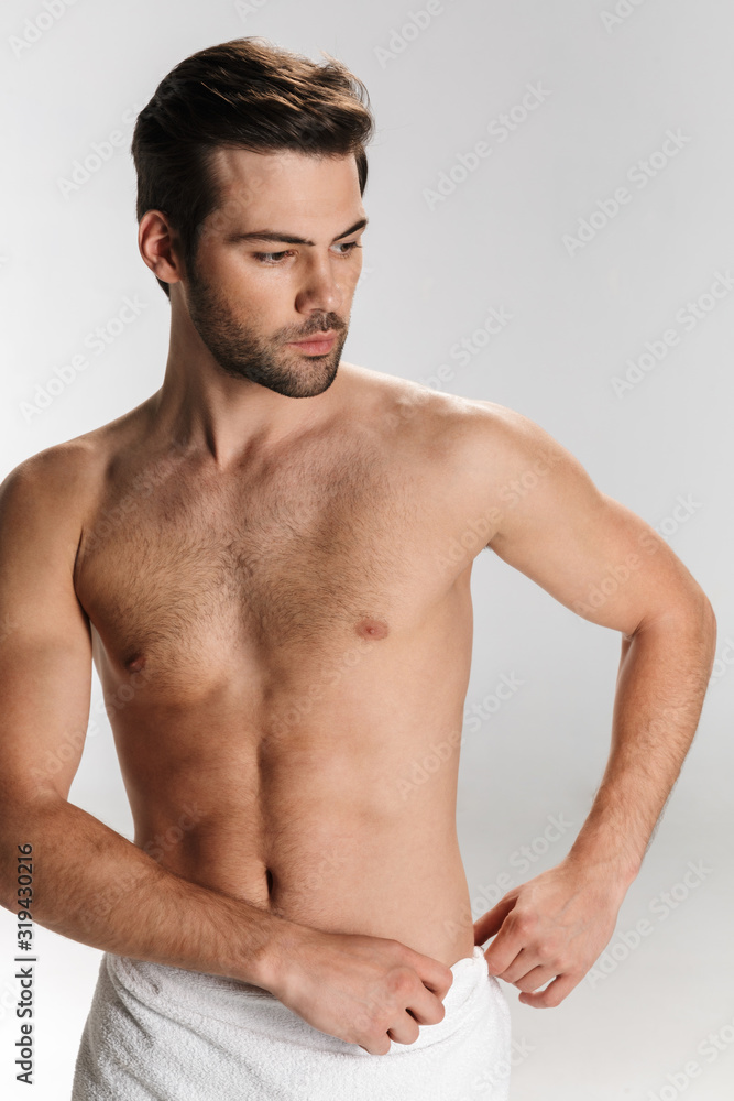 Photo of athletic half-naked man posing and looking aside