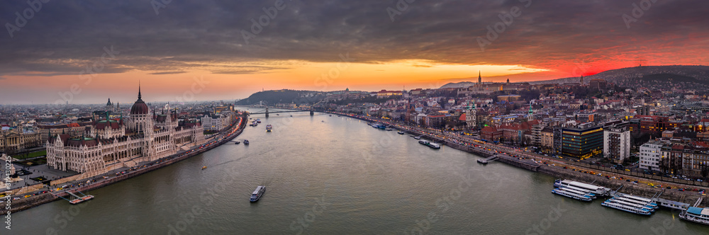 Budapest, Hungary - The Hungarian Parliament building on a large aerial panoramic photo with beautiful colorful winter sunset. Szechenyi Chain Bridge, Buda Castle and Fisherman's Bastion at background