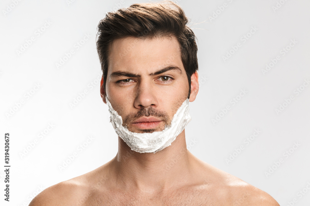 Photo of brutal half-naked man with shaving foam on his face Photo of brutal half-naked man with shaving foam on his face
