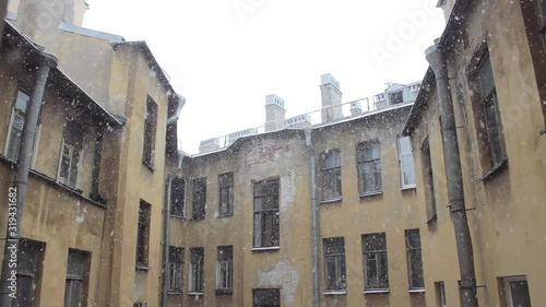 Wallpaper Mural heavy winter snowfall in the yard against the sky and the roof of the old yellow house with windows Torontodigital.ca