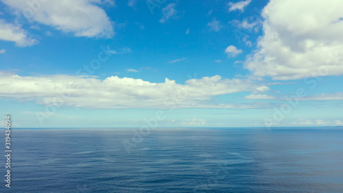 Seascape by day. Sea and sky with clouds in calm weather.