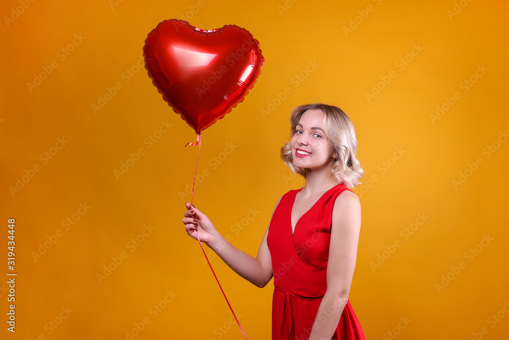 Portrait of young blonde woman posing with helium inflated air balloon. Happy valentine's day concept. Happy female with curled hair over colorful background. Close up, copy space for text. Portrait of young blonde woman posing with helium inflated air balloon. Happy valentine's day concept. Happy female with curled hair over colorful background. Close up, copy space for text.