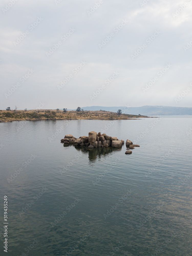 Curiosity rocks at Lake Jindabyne under the overcast sky. Curiosity rocks at Lake Jindabyne under the overcast sky.