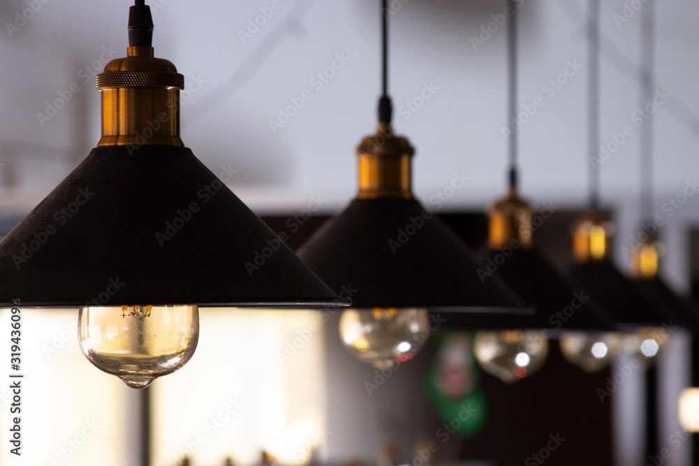 Obraz premium lamps in the cabin hang on wires. loft interior, black shade