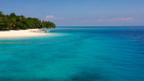 Seascape with a beautiful tropical island, aerial view. Beautiful white sand beach. Mahaba Island, Philippines. Blue sea with turquoise lagoons. Summer and travel vacation concept.