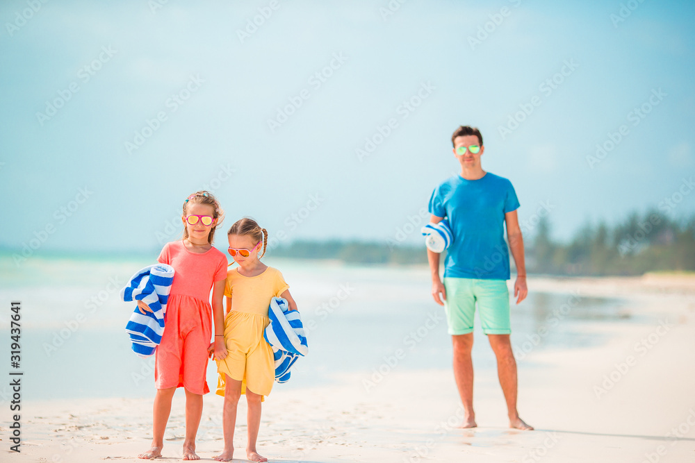 Father and little kids on the beach