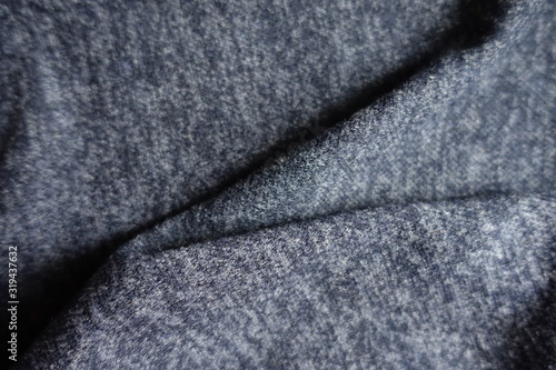 Folded dark heather blue woolen fabric from above © Anna