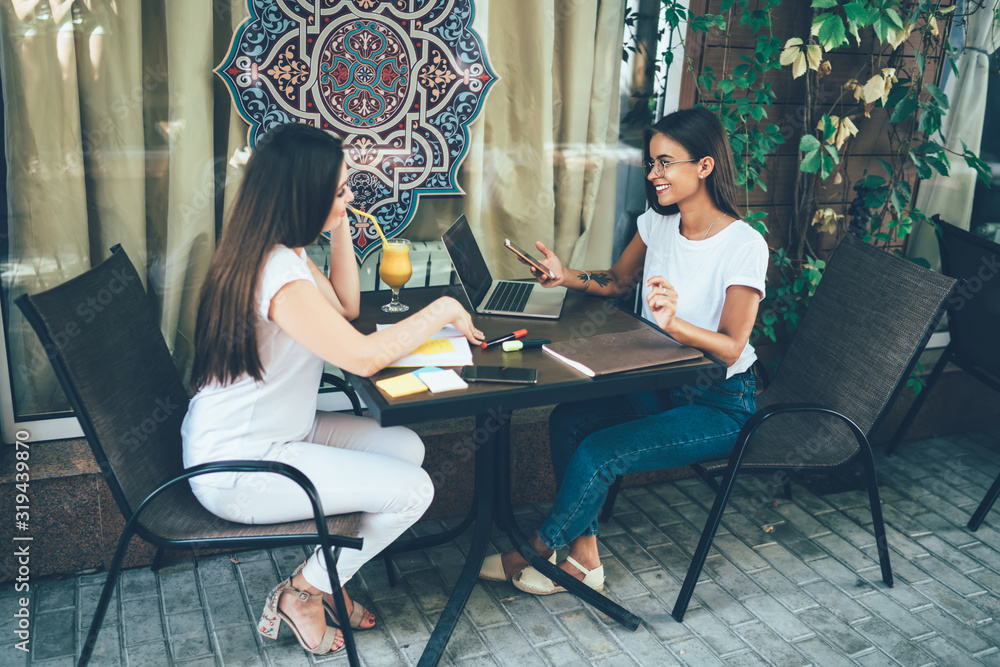 Female freelancers working in cafe together Female freelancers working in cafe together