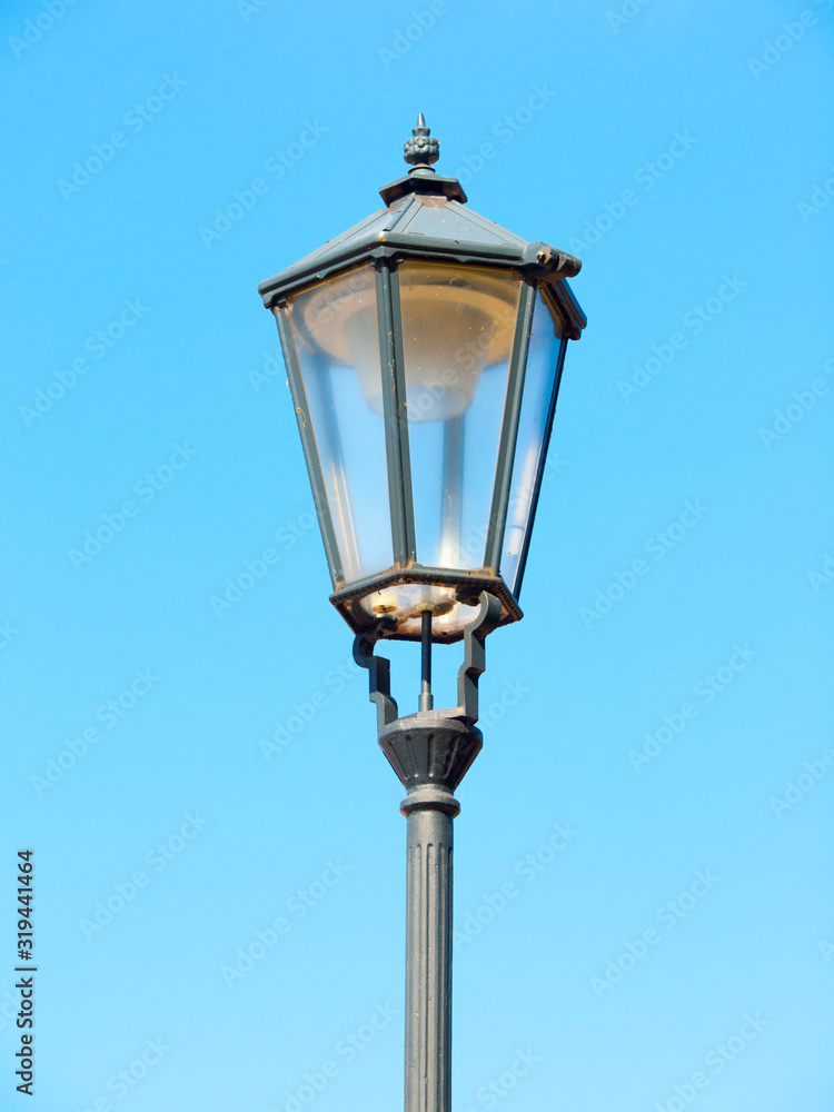 Old street lamp in Prague. Detailed view with blue sky background