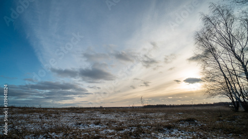 Beautiful setting sun over frozen field