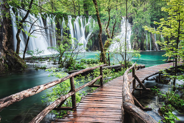 Tuinposter Watervallen Houten pad langs Plitvicemeren op regenachtige dag  © benowensmedia
