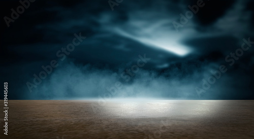 Futuristic empty night scene. Empty street scene background with abstract spotlights light. Night view of street light reflected on water. Rays through the fog. Smoke, fog, wet asphalt with reflection © MiaStendal