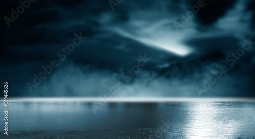 Futuristic empty night scene. Empty street scene background with abstract spotlights light. Night view of street light reflected on water. Rays through the fog. Smoke  fog  wet asphalt with reflection