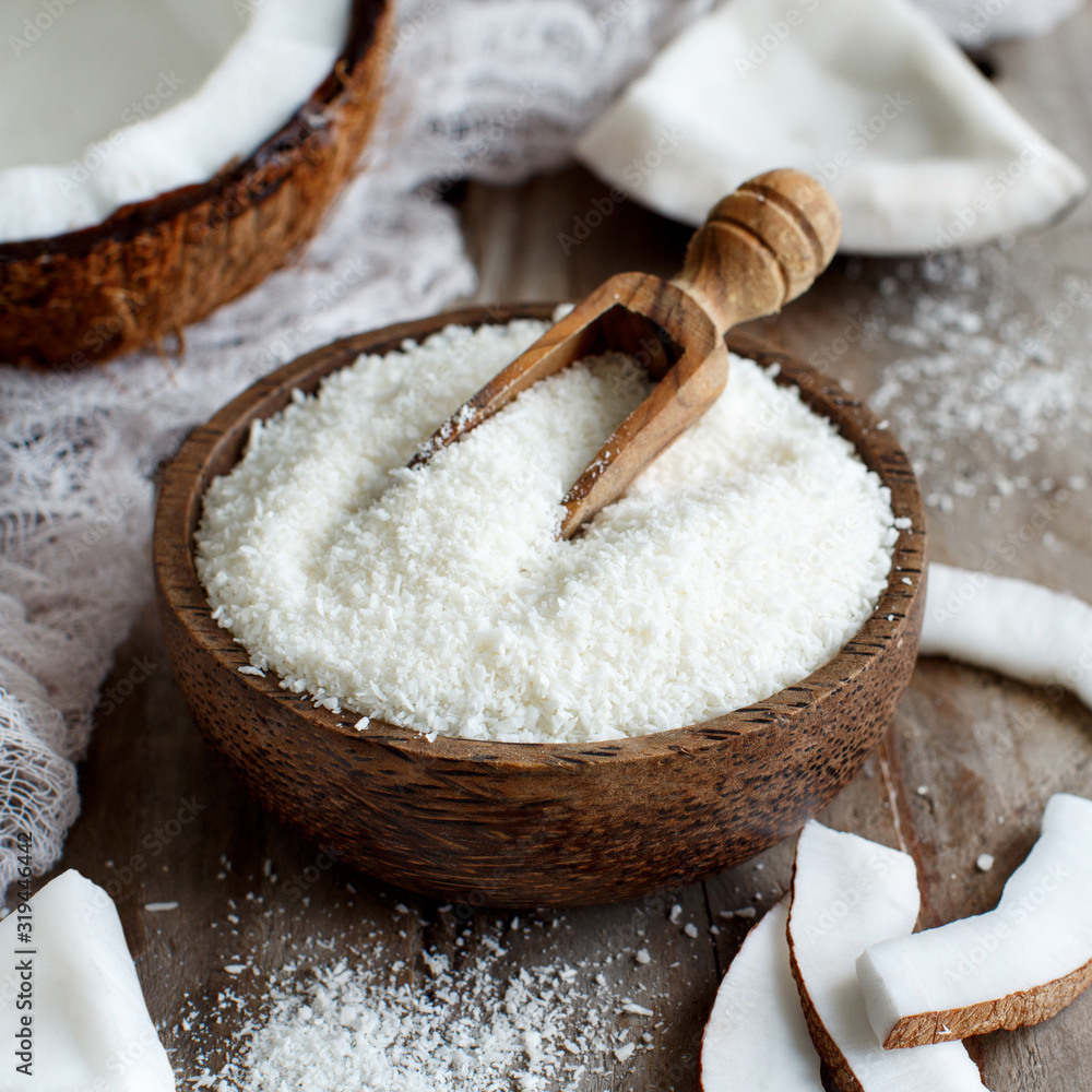 Coconut flour in a wooden bowl close up Coconut flour in a wooden bowl close up
