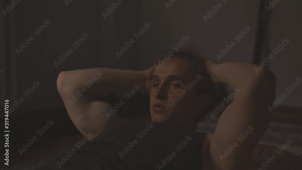 Young athletic sportsman doing crunches for abs workout indoors in early morning. Young athletic sportsman doing crunches for abs workout indoors in early morning.