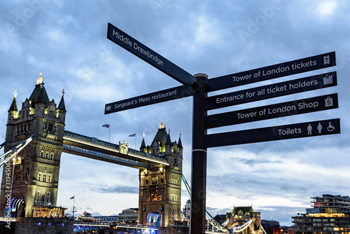 Direction sign on a background of Tower Bridge, London, UK photo